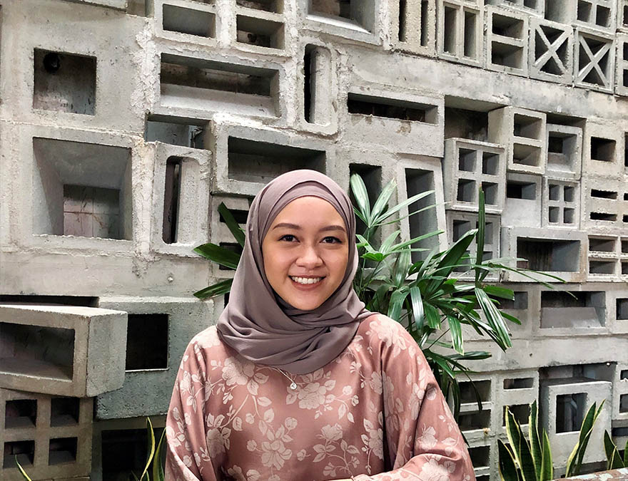 Portrait shot of Nadhirah Zakarya amid stoney background and green plants