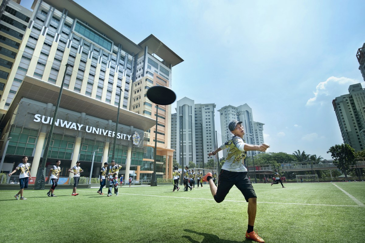 Students playing frisbee at Sunway University’s football field