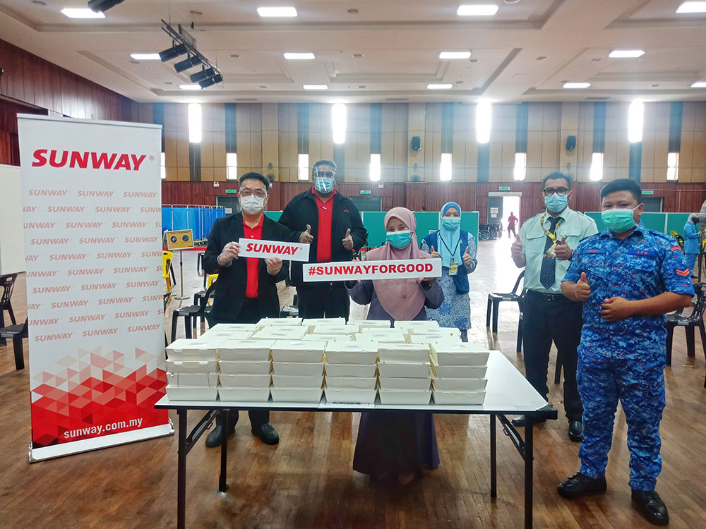 Frontline workers with the packed meals at Seberang Perai Arena Convention Centre, Penang