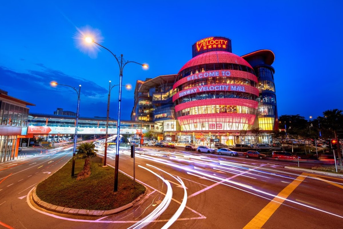 A wide-shot of Sunway Velocity during dusk with slow motion traffic lights captured depicting the fast-paced city life and Sunway Velocity Mall in the background