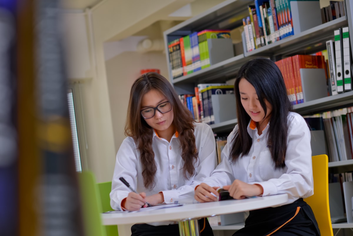 Two SIS students studying in the SIS library