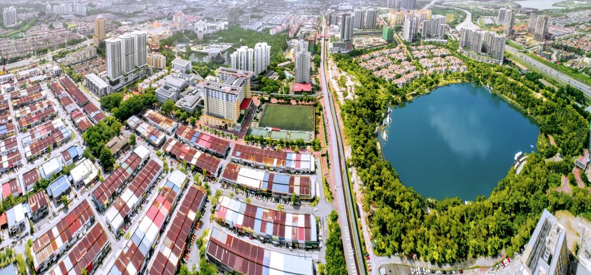 A panoramic drone shot of Sunway City Kuala Lumpur, with housing and the Sunway South Quay lake