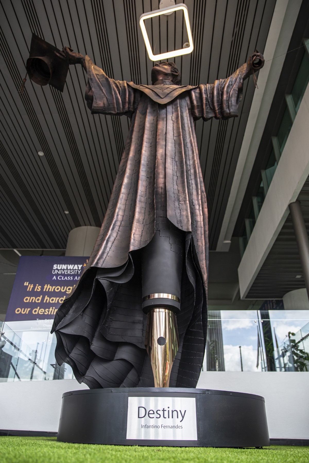 A portrait low-angle full-shot of sculpture ‘Destiny’ from its platform, pen tip base and all the way up to its glowing halo