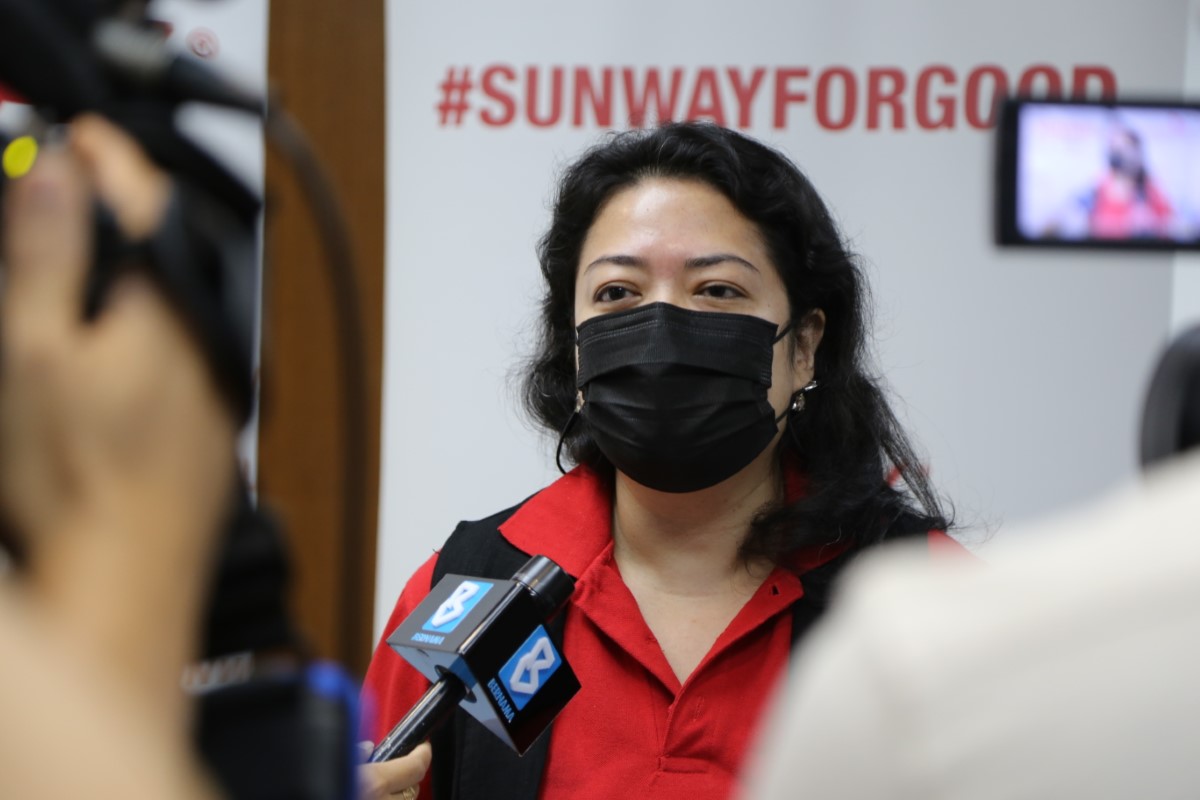 Ms. Nik Tasha Nik Kamaruddin, senior general manager of Sunway Group brand, marketing and communications being interviewed by Bernama, with the #SunwayforGood banner in the background