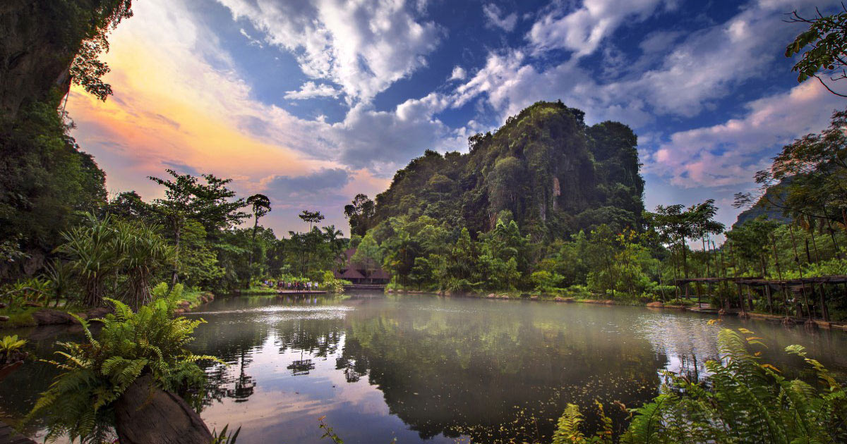 A wide angle shot of Banjaran Hot Springs Retreat in Ipoh, Perak, with its colour saturation manipulated to present a majestic allure, its evening sky tinged with a pastel orange and pink at the far left corner.