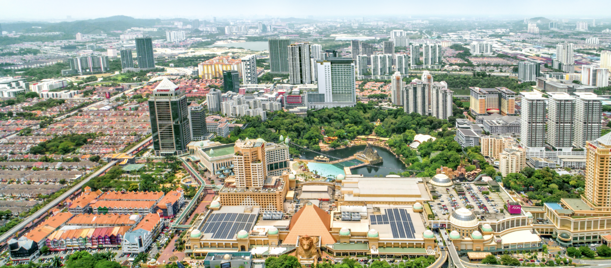 A bird’s eye view of Sunway City Kuala Lumpur at daytime, with the infamous Sunway Pyramid lionhead being front and centre, surrounded by other key SCKL landmarks, lush greenscapes and city skylines