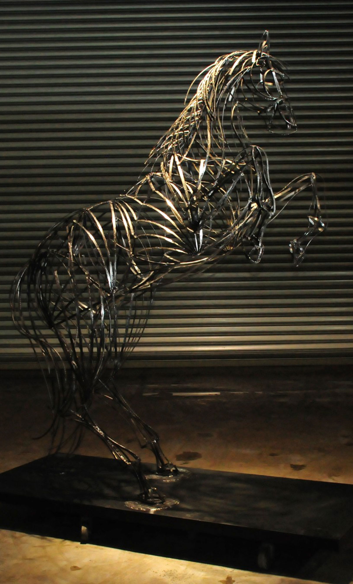 A steel line sculpture of a horse called ‘Gallop’ on its two hind legs in a rearing position.