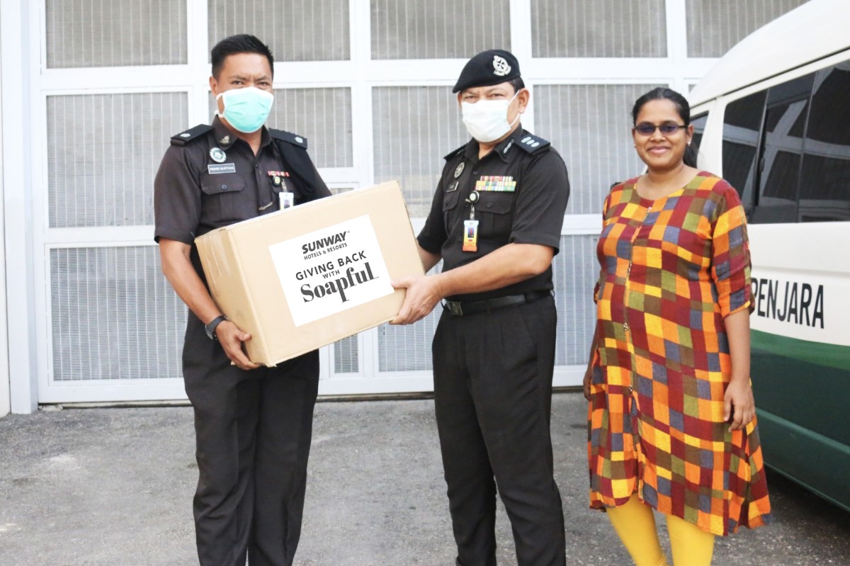 A shot of police officers receiving essential goods from Sunway Resorts & Hotels
