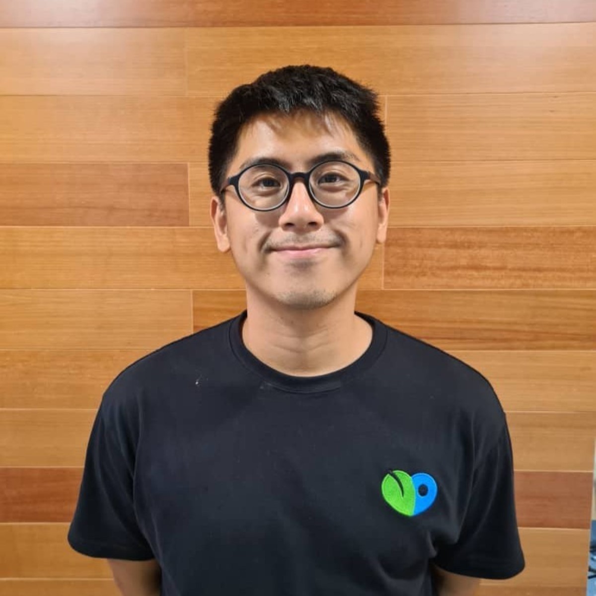 A loose close-up of Loop Foods and SpargoEats founder Nicholas Ou beaming proudly in SpargoEats’ uniform