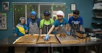 Candid shot of GOLD trainees preparing cookies