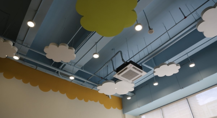 A landscape shot of the ceiling design of Sunway Little Sunshine Childcare Centre, featuring smoke alarms and air conditioners installed with UV lights to ensure quality upper air flow