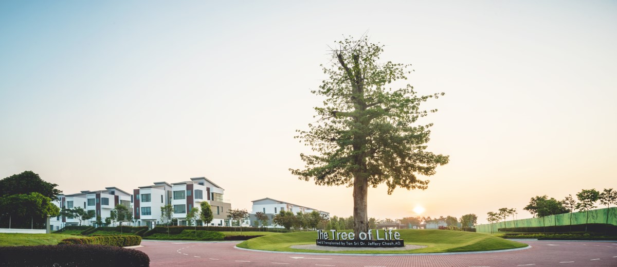 A side-angle shot of the gargantuan Tree of Life at Sunway Lenang Heights accompanied by houses in the background