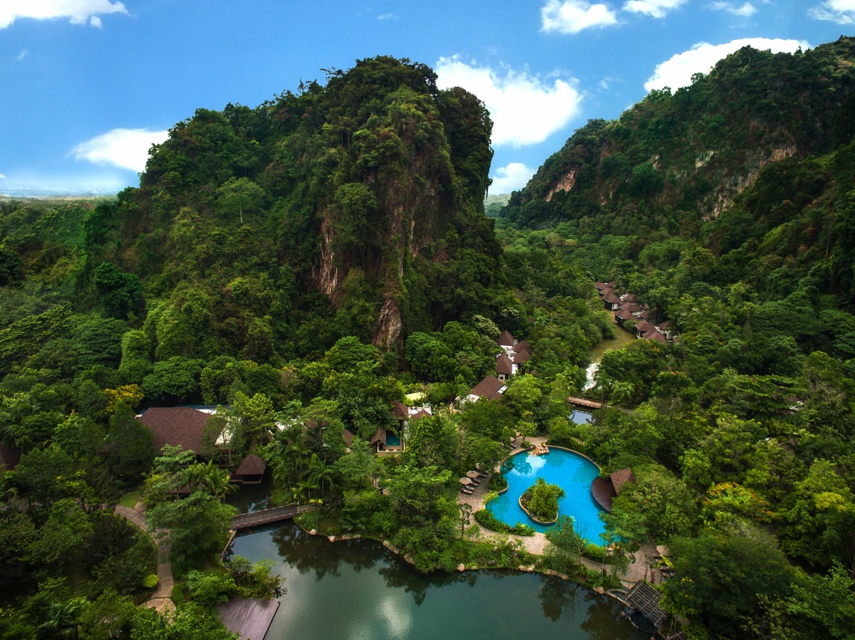 A high-angle shot of Banjaran Hotsprings Retreat alongside rainforest filling up the background