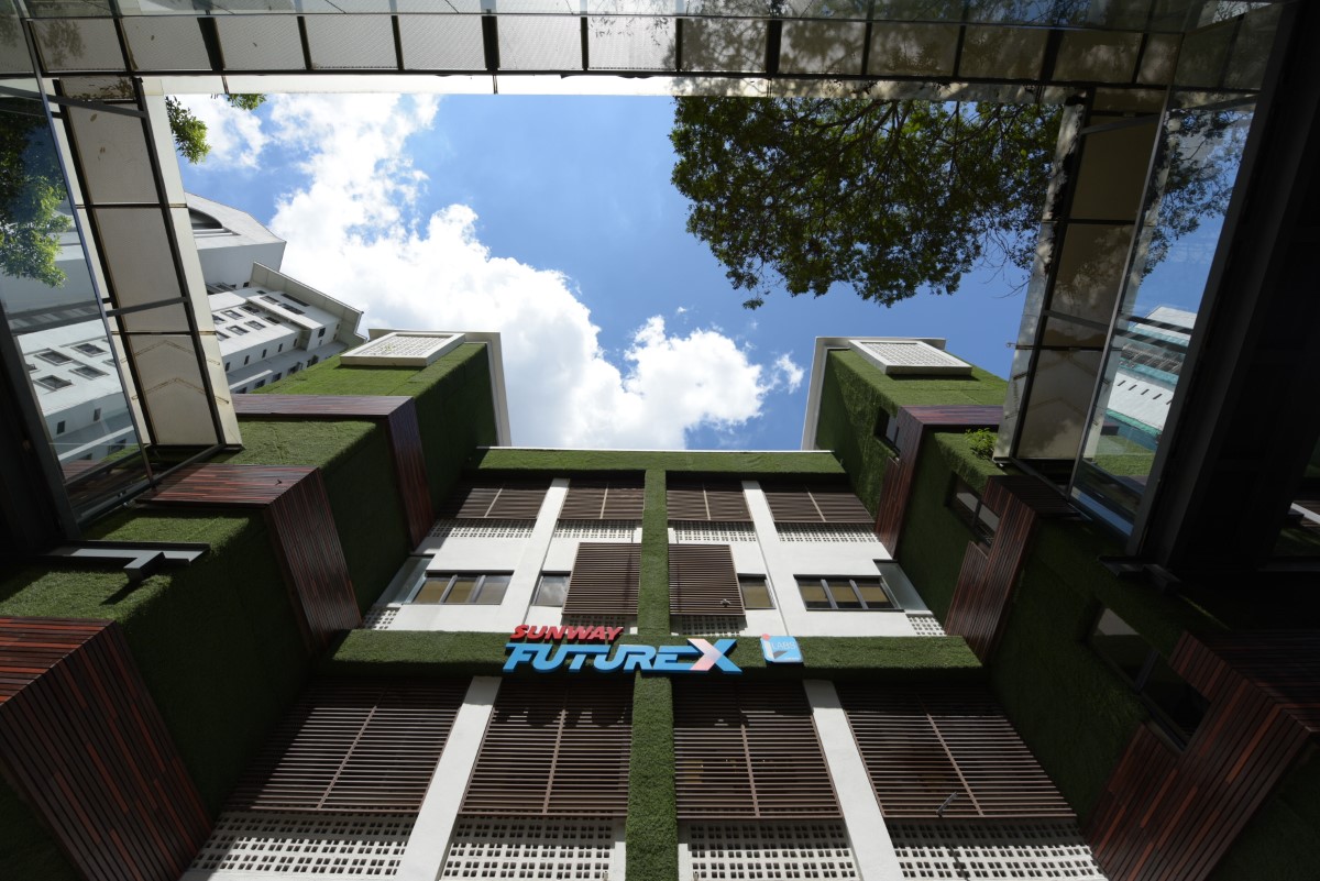 A low-angle landscape shot of Sunway FutureX building façade in Sunway City Kuala Lumpur under clear blue sky