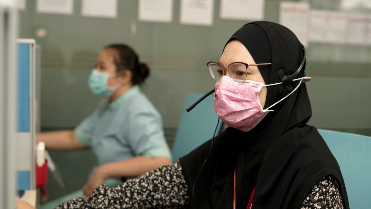 Masked-clad medical officers handling the telemedicine centre