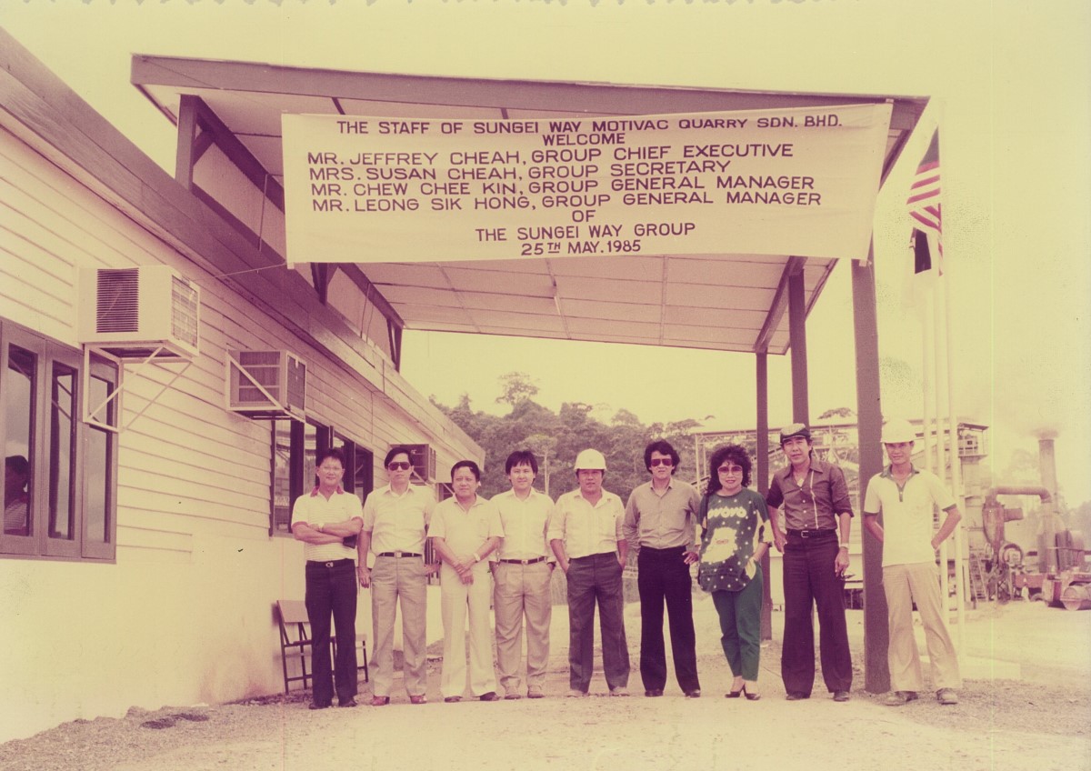 A sepia photo of the first office of Sunway Group – a small warehouse with a simple signage of the staff of Sunway