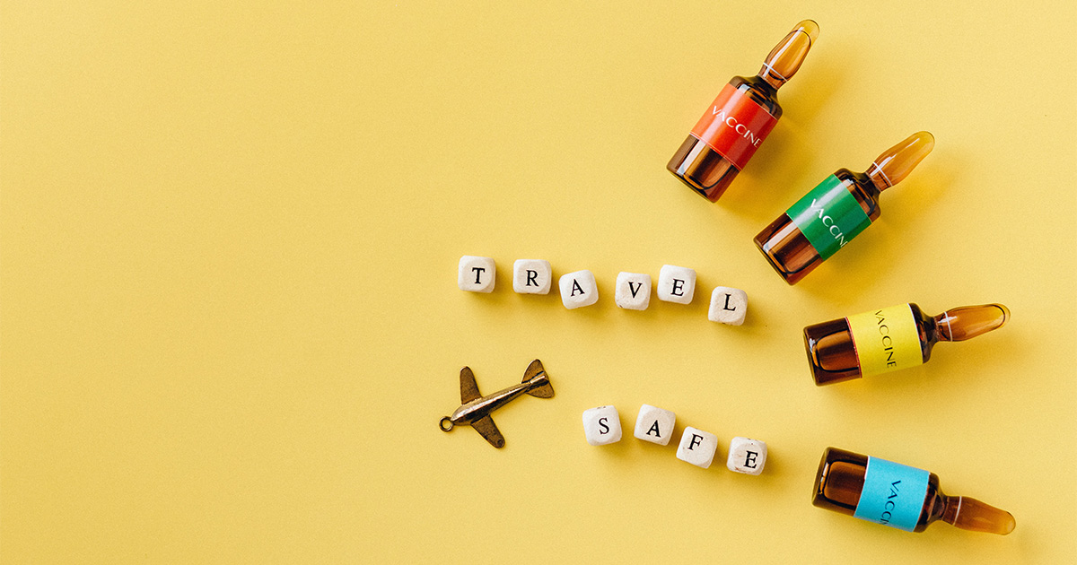 Flat lay representing the importance of travelling safely and being vaccinated