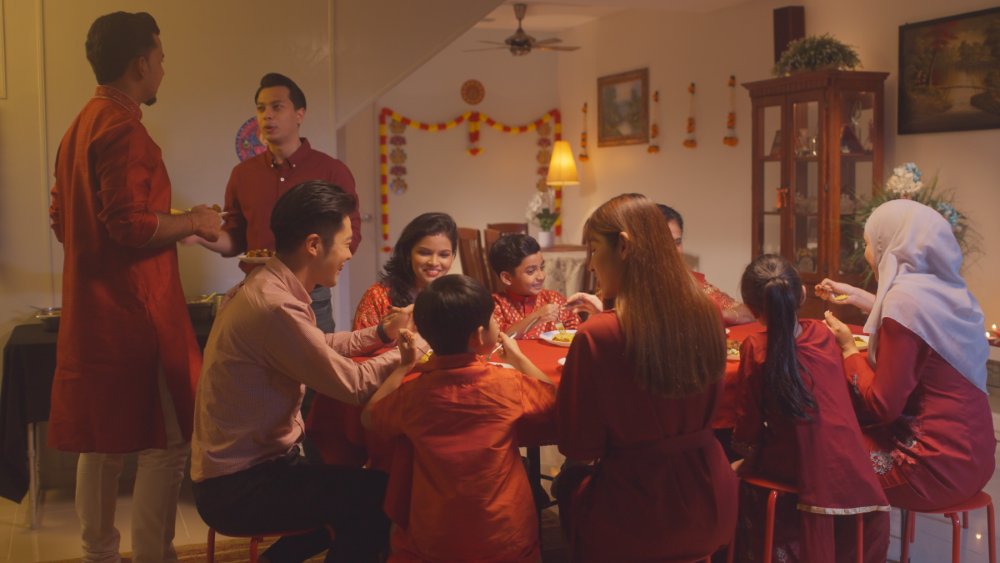 The families coming together during Deepavali celebrations, with the people casually chatting with each other during dinner.