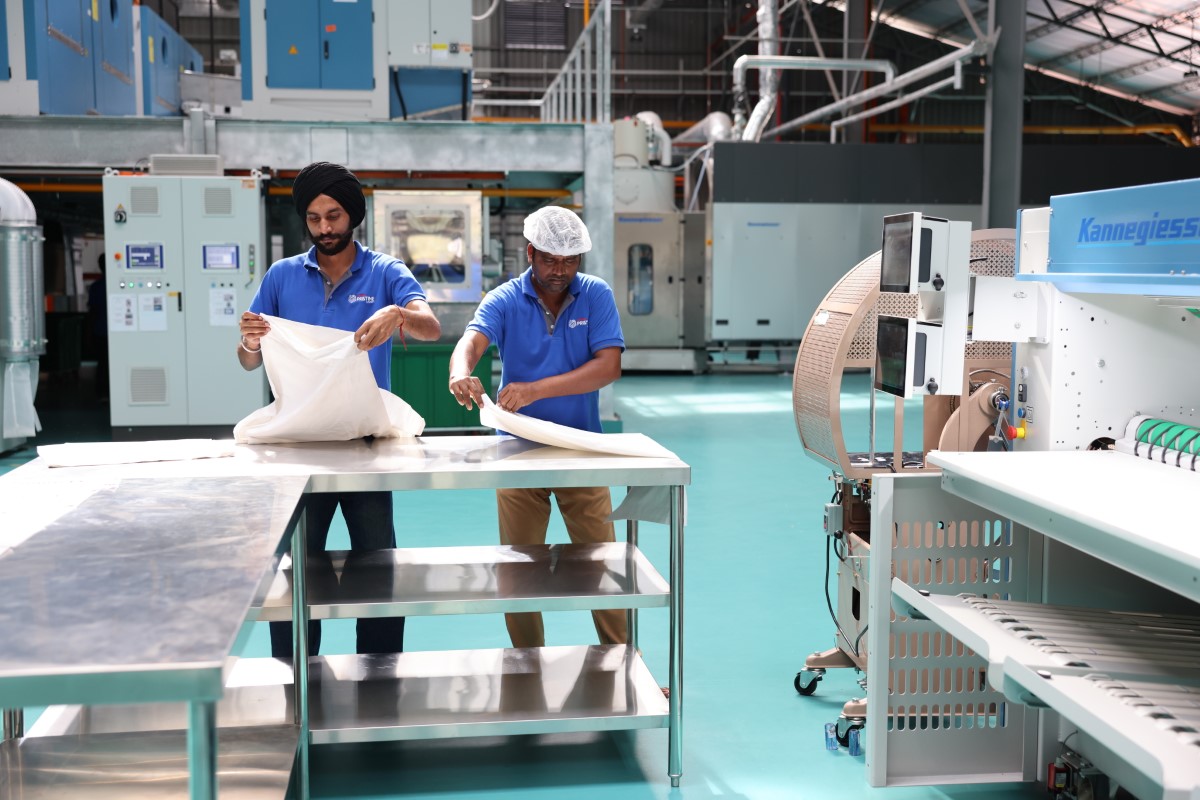 Candid shot of two workers at the laundry plant