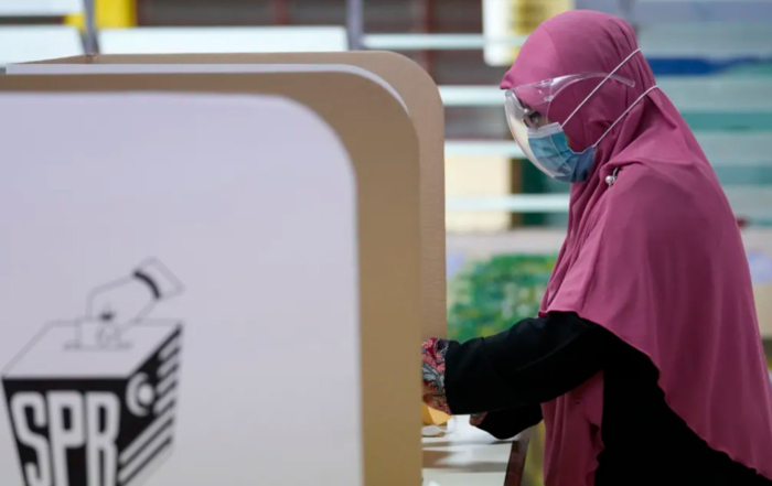 Candid shot of Malaysian woman casting her vote
