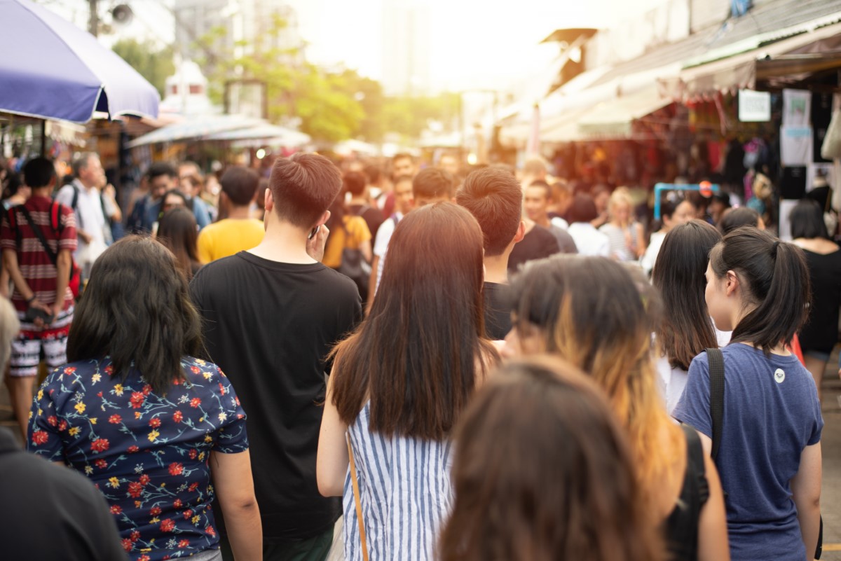 Anonymous crowd and people walking at a weekend market