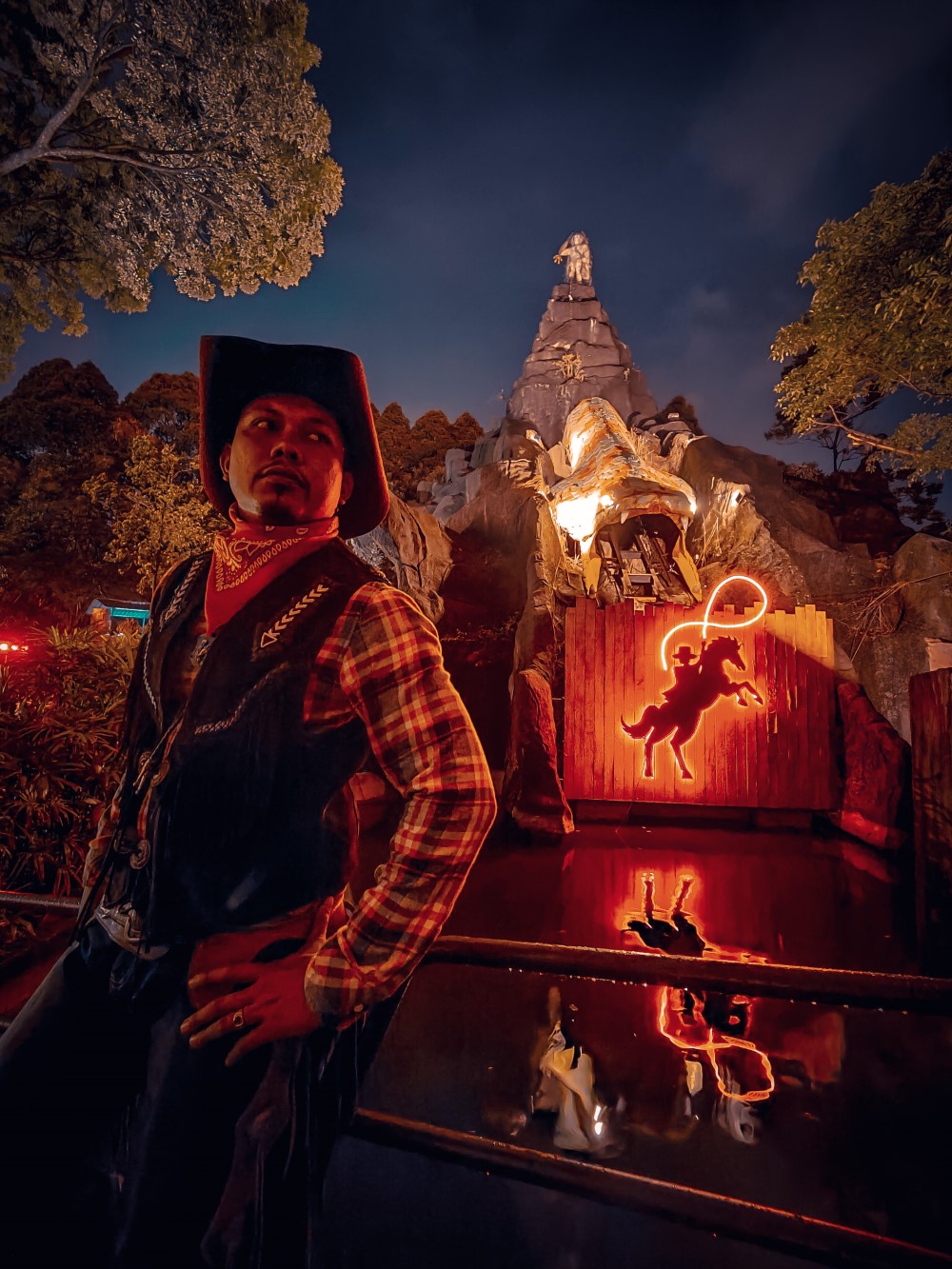 A portrait of Sunway Lagoon’s cowboy posing afront Wow Wild West Night Park’s star attraction.