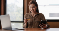 Candid shot of a lady purchasing items with a credit card