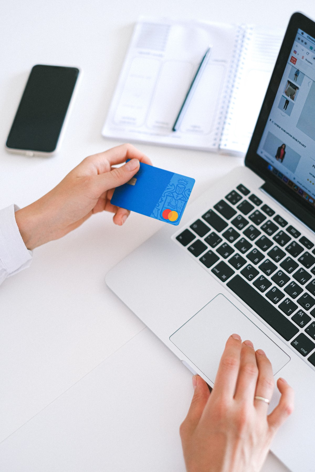 A close-up shot of a laptop and credit card