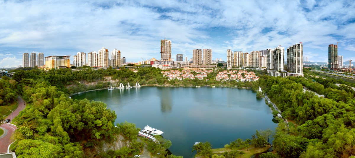 An overview shot of Sunway South Quay lake, featuring the Sunway City skyline and greeneries.