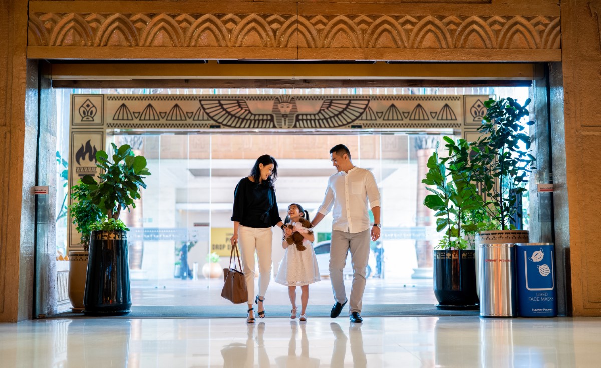 A family walking through the Sunway Pyramid Mall entrance