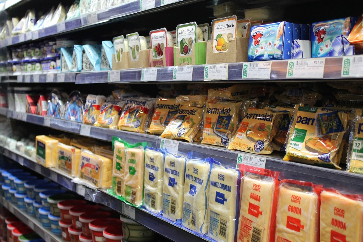 A landscape shot of processed food organised neatly in rows at a commercial grocery store.