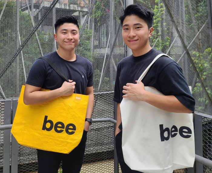 A portrait of Beebag co-founders Joshua and Joel Lim proudly flaunting their creation – the Beebag that comes in shades of vibrant yellow and mellow off-white.