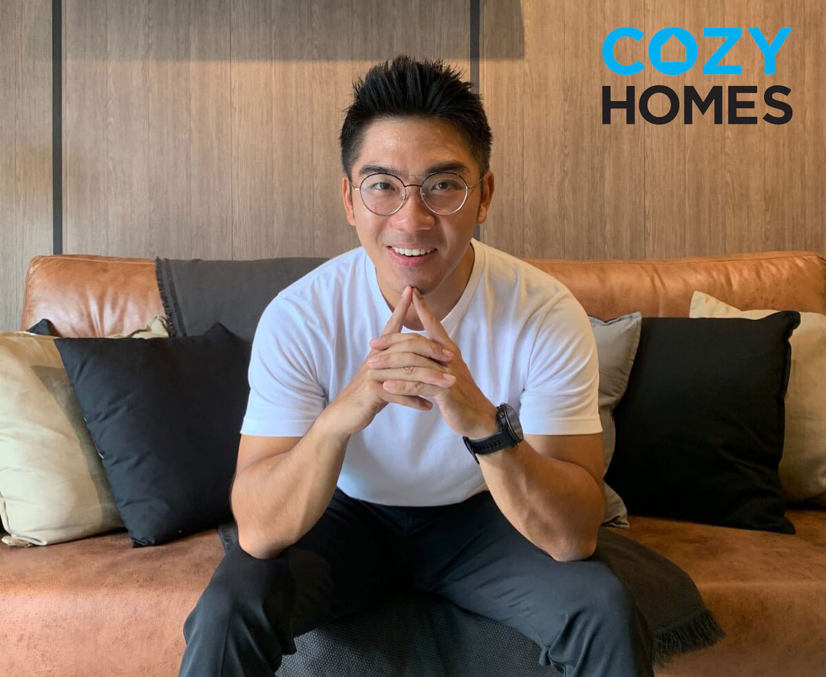 A portrait of CozyHomes founder Vincent Lim assuming a relaxed stance with both elbows on both knees at their local headquarters.