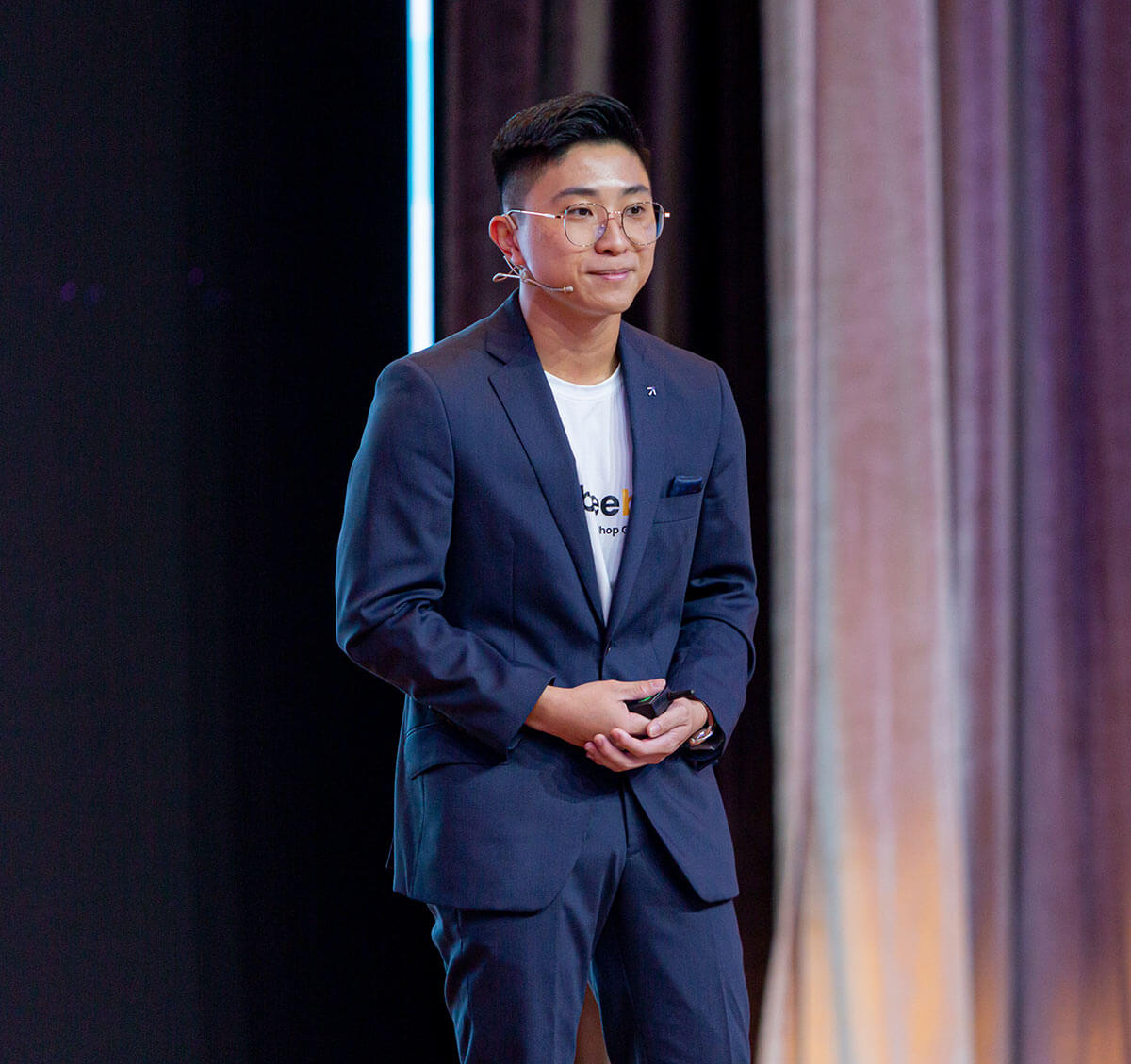 A portrait of Beebag co-founder Joshua Lim presenting on-stage during United Nation’s Sustainable Development Solutions Network (UN-SDSN)'s inaugural National Solutions Forum (NSF) 2022.