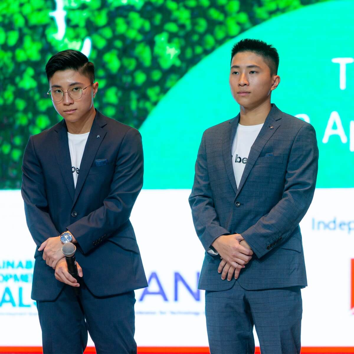 A portrait of Beebag co-founders Joshua and Joel Lim mid-presentation on-stage during United Nation’s Sustainable Development Solutions Network (UN-SDSN)'s inaugural National Solutions Forum (NSF) 2022.