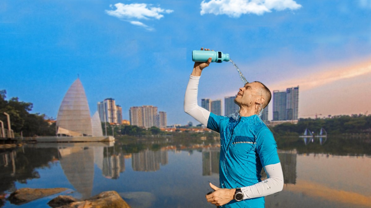 Candid image of man pouring drinking water on his face