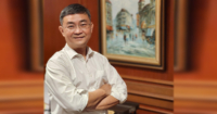 Head shot of Mr. Ong Pang Yen, executive director of chairman’s office at Sunway Group. A mid-shot photo with a portrait in the background.