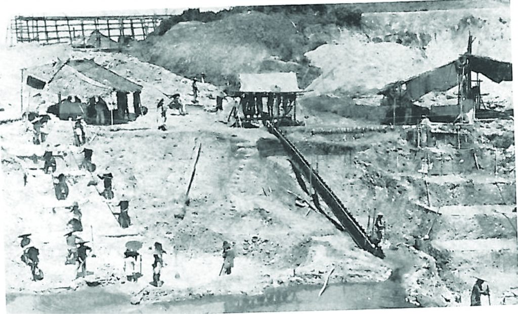 A historical, black-and-white shot of tin mining in Perak