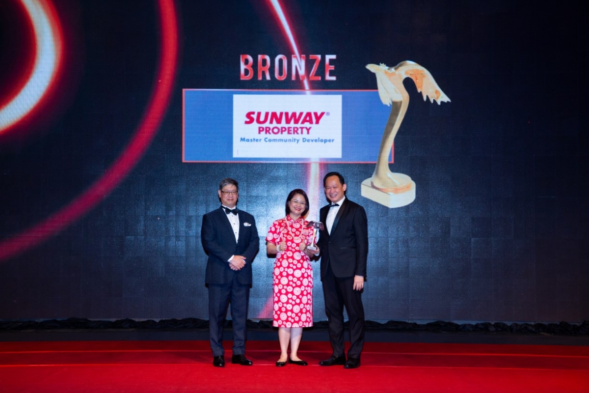 A full landscape photo of Sunway Property chief brand and marketing officer Gerard Yuen receiving the Putra Bronze award on stage for the category of Property