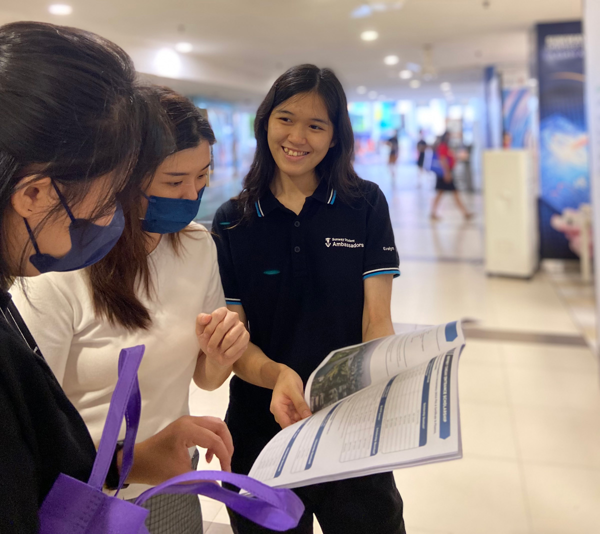 Evelyn Wee providing a prospectus for potential students during Open Day at Sunway University.