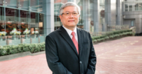 A mid shot of Dato’ Lau Beng Long, president of Sunway Healthcare Group (SHG) standing in front of the façade of Sunway Medical Centre