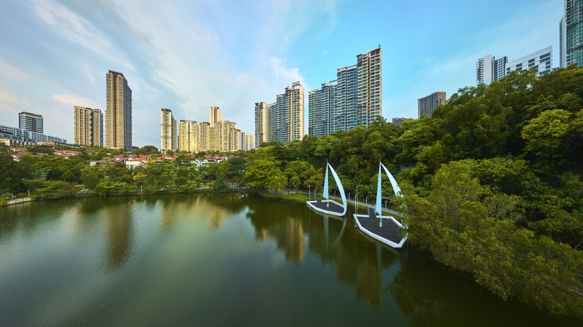 A panoramic shot at South Quay lake at Sunway City Kuala Lumpur, with trees and skyscrapers in the background