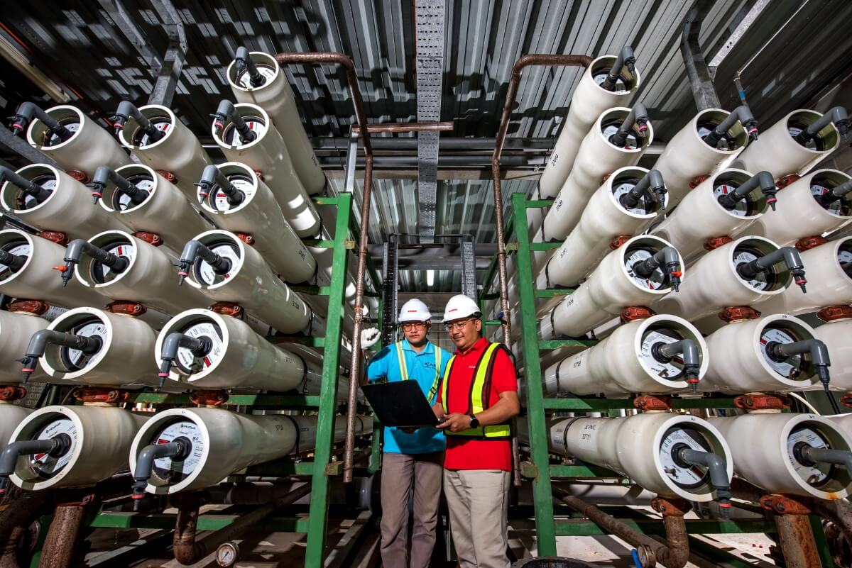 A shot of Sunway’s water treatment plant. With pipes and two workers in the middle.