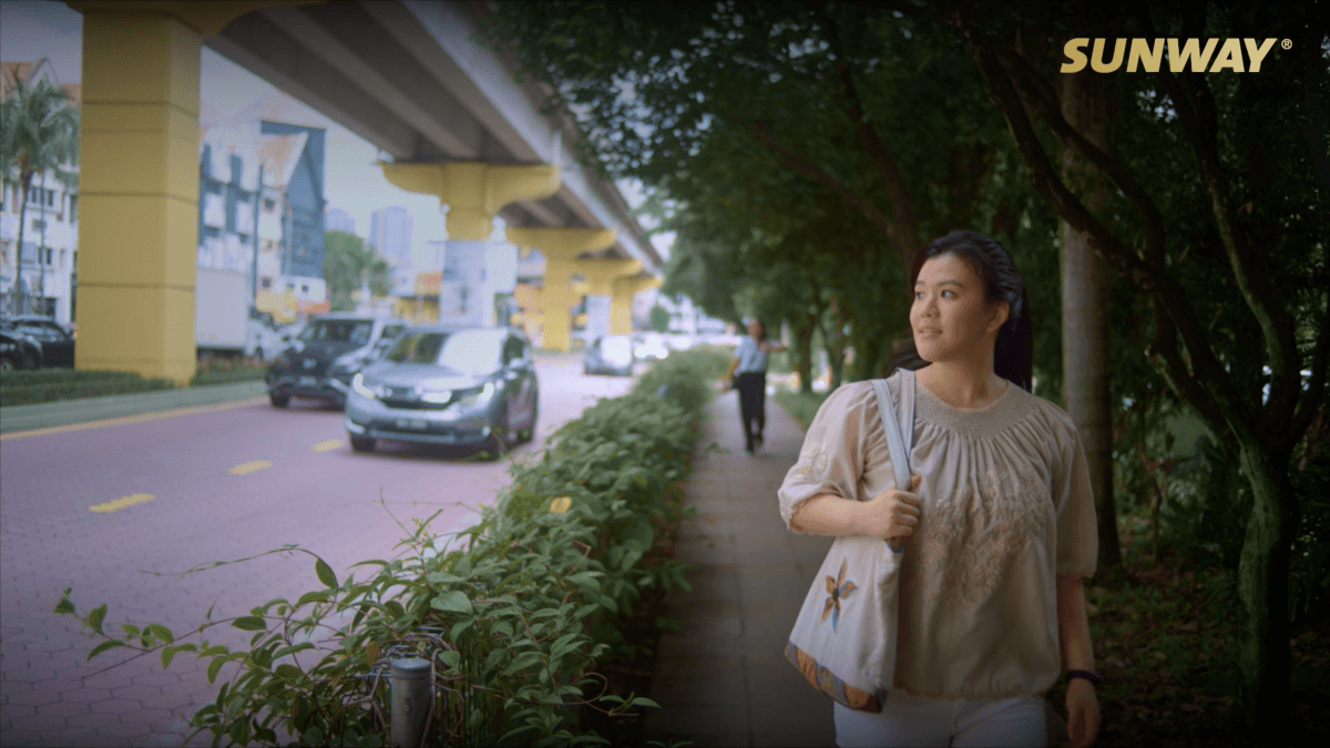 Alycia Wong, a long-time resident of Sunway City Kuala Lumpur, walking on the sidewalk at Sunway City Kuala Lumpur