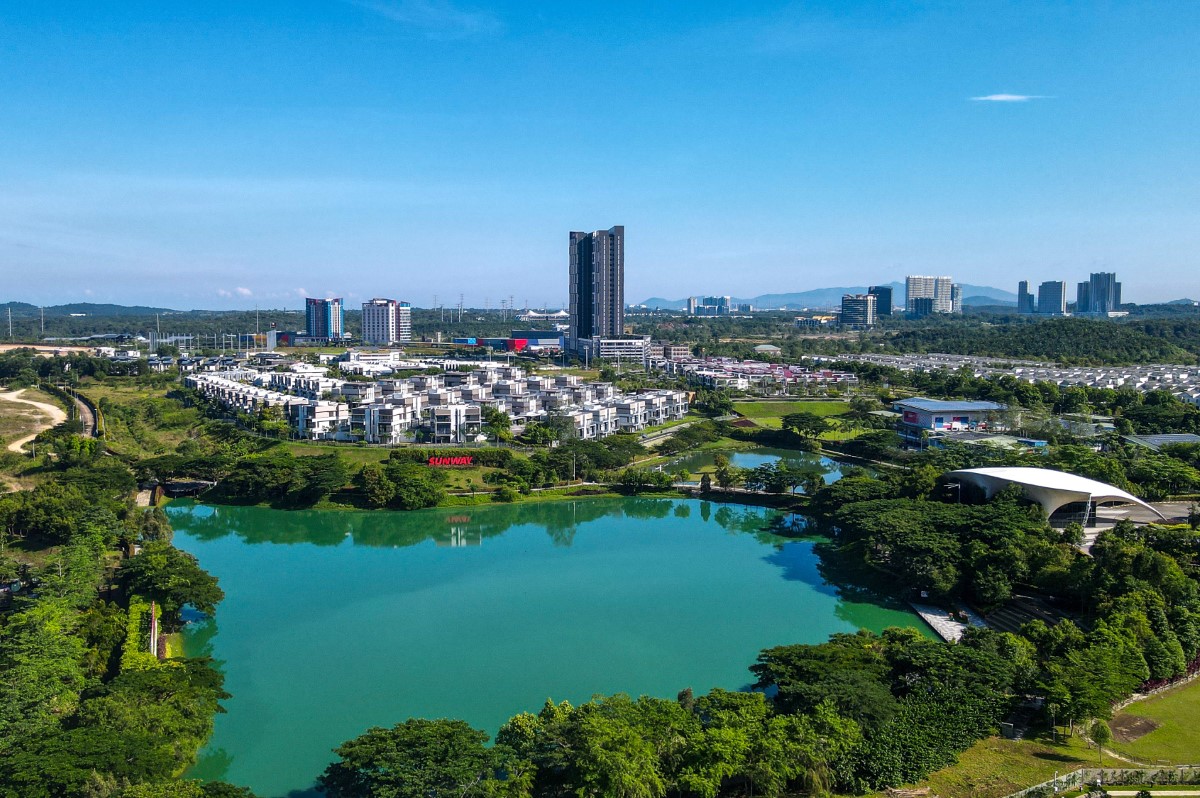 A drone shot of Sunway City Iskandar Puteri, with the Emerald Lake in the foreground and Sunway Big Box in the background