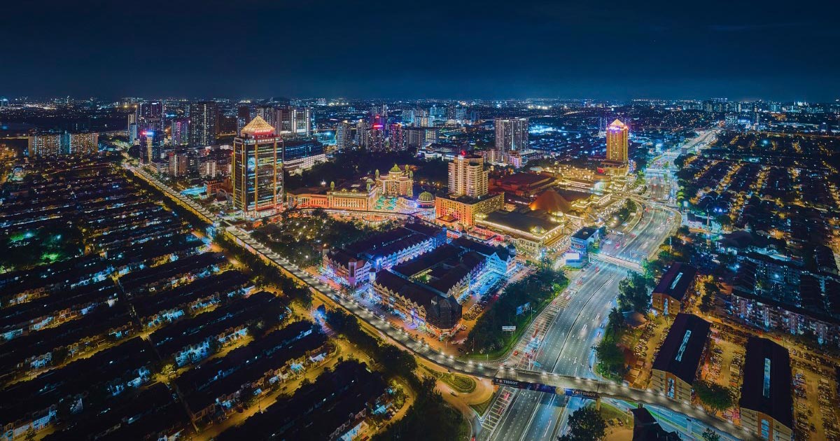 A drone night shot of Sunway City Kuala Lumpur, featuring resplendent lights and a digitalised look.