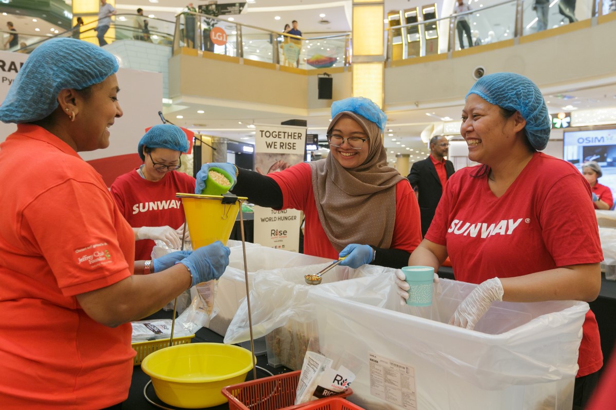 A medium shot of our Sunway volunteers at a Rise Against Hunger Pack-a-Thon event, packing rice packets for underserved communities.