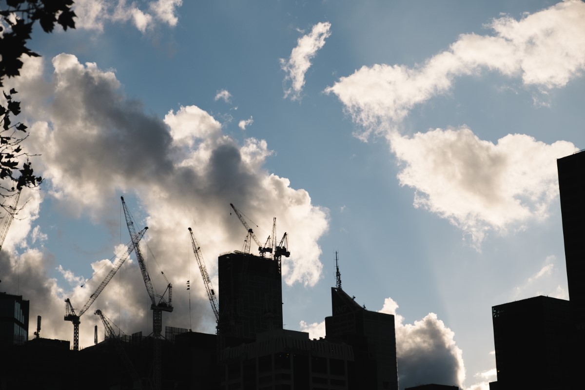 A silhouette shot of buildings, with the clouds in the sky as background.