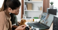 Mother and her child consulting a doctor online through a laptop. Along the laptop were a plush toy dog, some bottles of medicine and a glass of water.